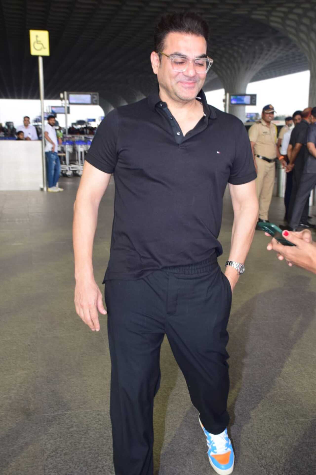 Actor Arbaaz Khan was spotted at the Mumbai airport in a pair of black joggers and a black polo collar t-shirt, pairing it with colourful shoes. His wife Sshura Khan was also at the airport to drop her husband